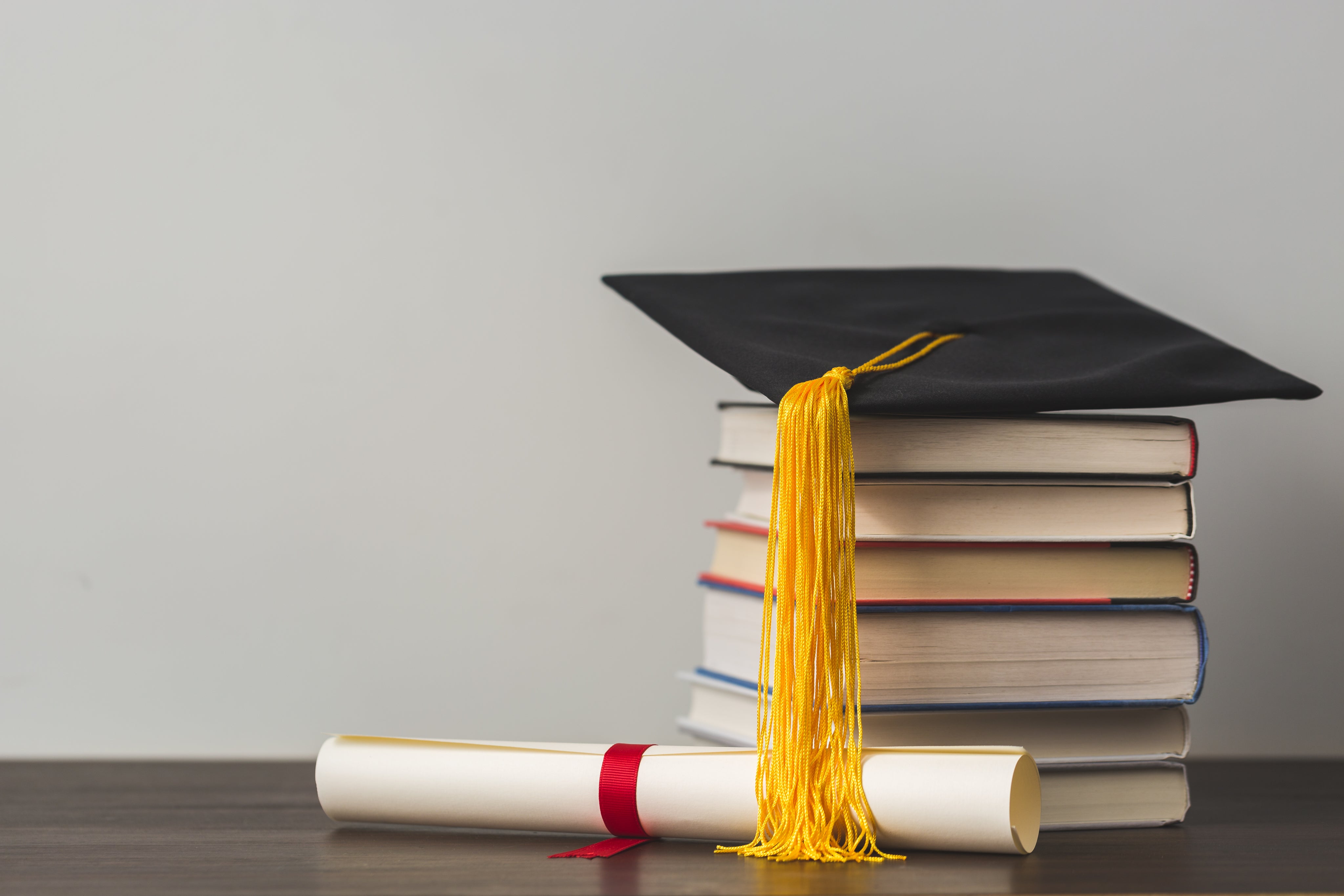 grad-cap-diploma-and-stacked-books.jpg